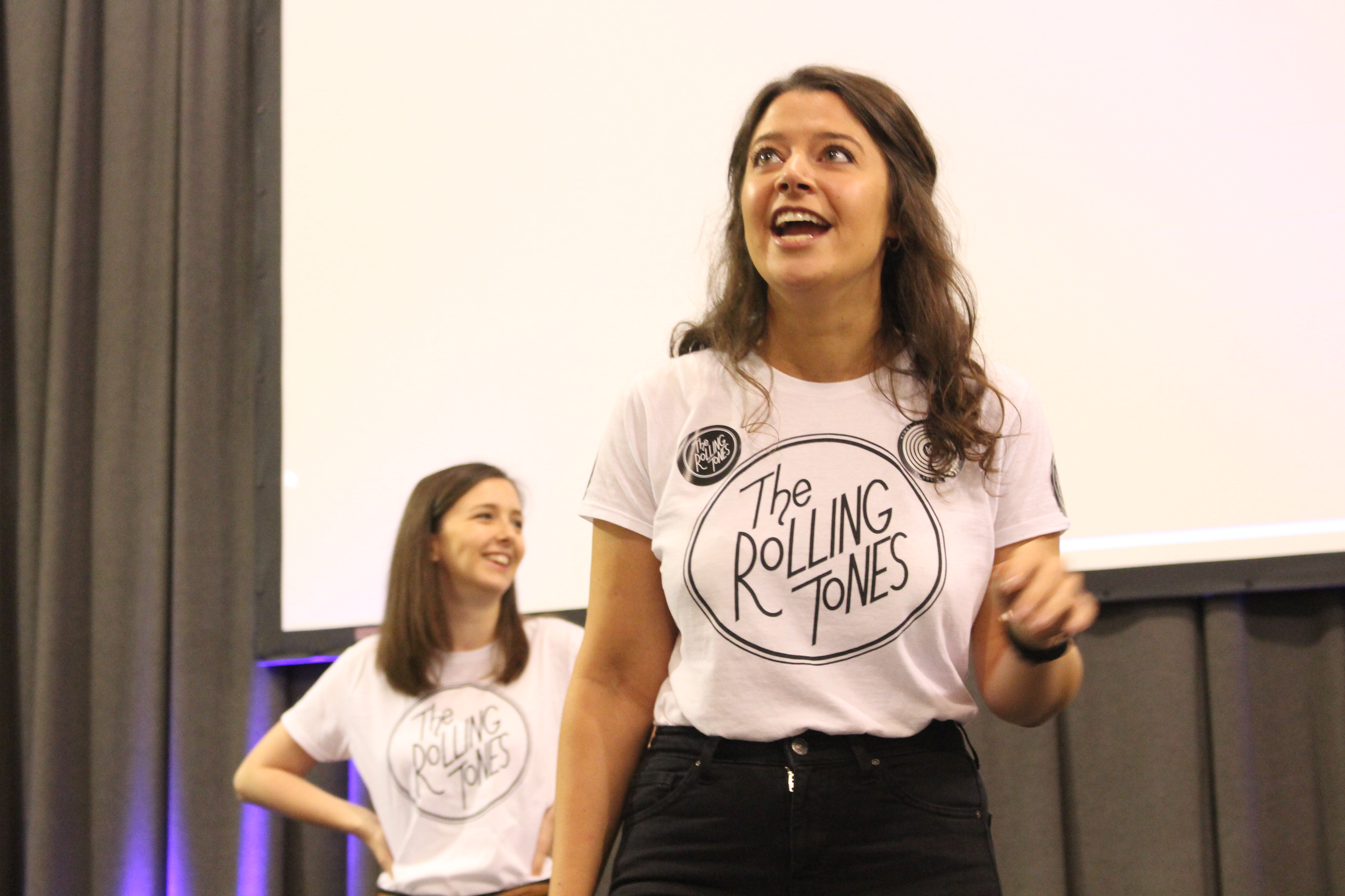 Students standing on a stage.