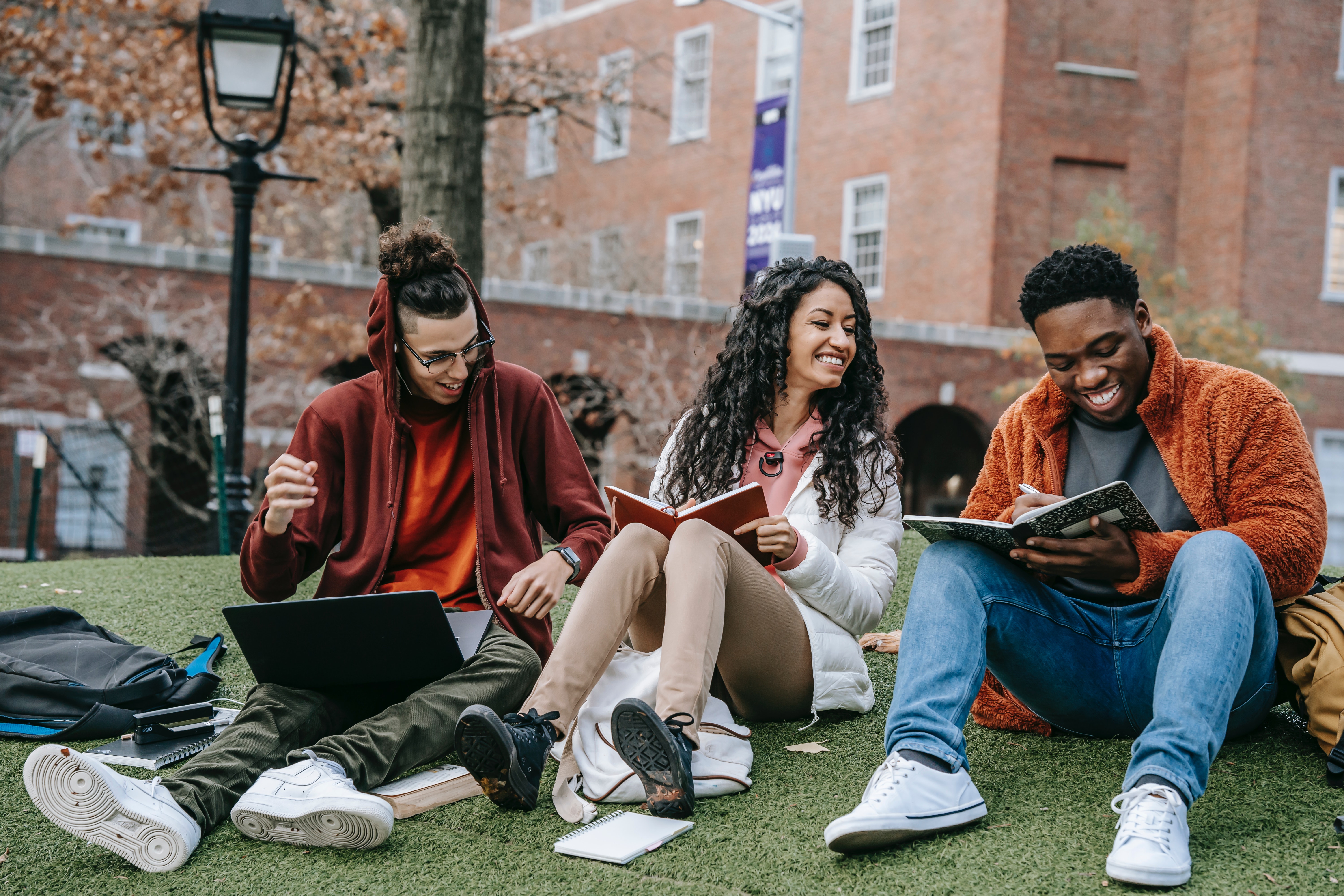 Photo by Keira Burton: https://www.pexels.com/photo/cheerful-multiethnic-students-with-books-sitting-near-university-6146978/