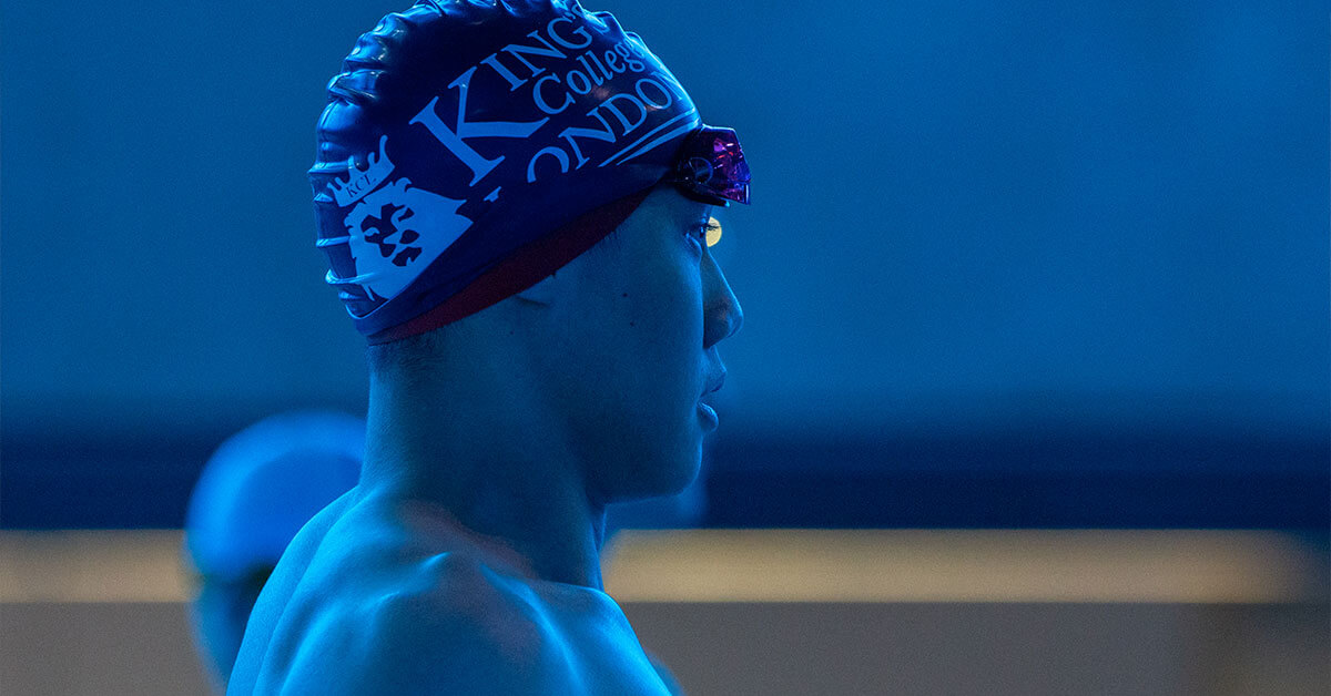 A King's swim team competitor stood by the pool